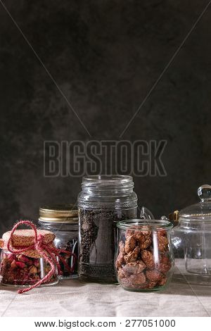 Tea Collection. Black Dry Tea In Jar, Rose Buds, Empty Glass Teapot, Cream Jug, Sweet Sugared Almond