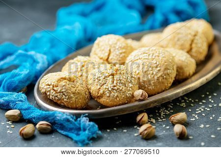 Traditional Moroccan Sesame Cookies On Metal Plate, On A Dark Textured Background. Selective Focus.