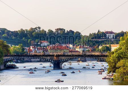 Paddleboats In The Vltava River Under Manes Bridge And Charles B