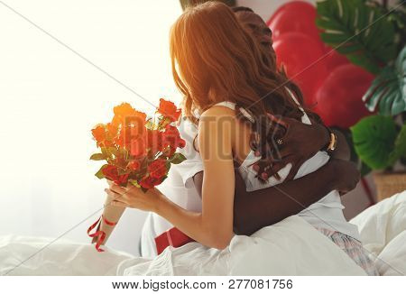 Valentine's Day. Happy Couple  With Red Hert And Flowers In Bed.