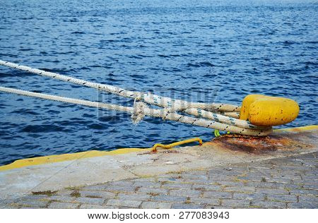 Yellow Dock Fitting With Towline On A Pier In Kavala