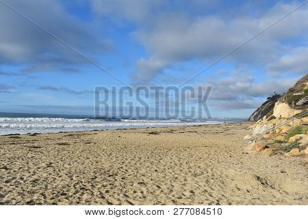 Pretty Beach With Waves Crashing Onto The Sand