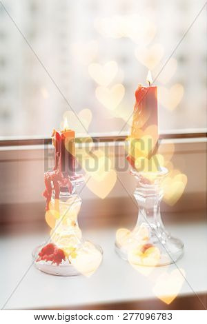 St. Valentine's Red Candles On The Windowsill