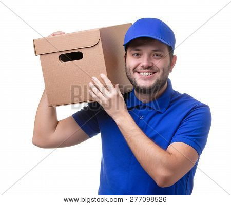 Picture Of Man In Blue T-shirt And Baseball Cap With Cardboard Box On Shoulder Standing On White Bla