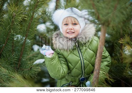 Girl Playing Snowballs. Funny Little Girl Having Fun In Winter Park. Making Snowballs Happy Child Gi