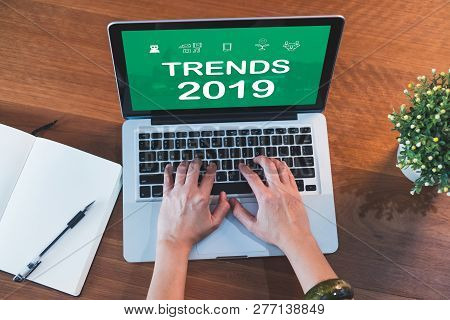 Top View Hand Type Trends 2019 On Laptop Keyboard With Open Notebook And Plant On Table At Home.work
