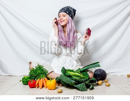 Beautiful Caucasian Vegan Woman With Vegetables Sitting On A Flooor. Spring Time Concept And Healthy