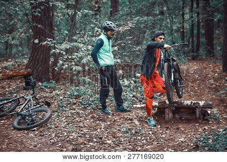 Moscow, Russia - Nov, 2018: MTB teacher helping rider learn to ride bicycle. Teaching a rider to rid