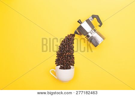 Coffee Beans Pouring From Coffee Maker Into Cup On Yellow Background. Love Coffee Concept. Flat-lay,