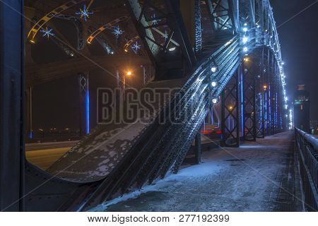 Snowstorm In Winter In The City At Night. Bolsheokhtinsky Bridge In St. Petersburg, Russia
