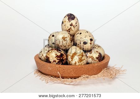 Closeup Easter Small Fresh Textural Quail Eggs In Round Wooden Bowl With Textile Isolated On White B