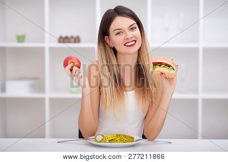 Attractive Young Woman Makes A Choice Between Healthy And Unheal