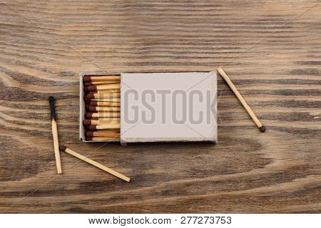 Matches With Brown Gray In A Matchbox On A Wooden Table