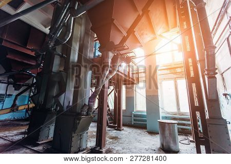 Abandoned Flour Milling Factory. Rusty Broken Pipeline And Mechanisms