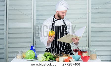 According To Recipe. Man Bearded Chef Cooking Food. Guy Read Book Recipes. Culinary Arts Concept. Ma