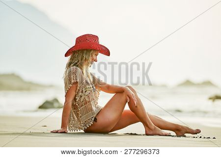 young woman relaxing on the beach in summer day