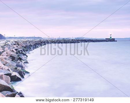 Shinning Lighthouse At The End Of Stony Pier. Cloudy Eveningafter Rainy Day, Sassnitz, Germany