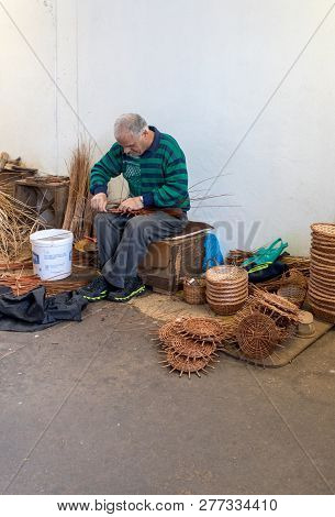 Camacha, Madeira, Portugal - April 19, 2018: A Basket Weaver At Work In The Factory Shop In Camacha 