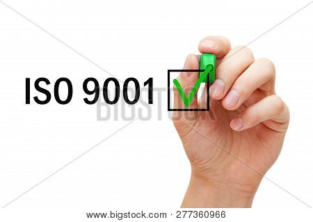 Hand Putting Verification Check Mark On Iso 9001 Quality Management System Certification With Green 