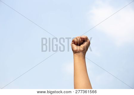 Woman Arm With Fist Raised In The Air.
