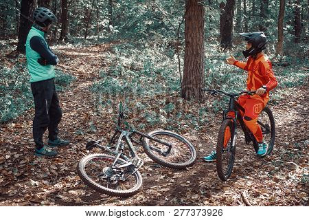 Moscow, Russia - Nov, 2018: MTB teacher helping rider learn to ride bicycle. Teaching a rider to rid