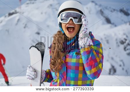           Happy Young Woman Skier Enjoying Sunny Weather In Alps Stock Photo                     