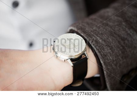 Btc. A Businessman Investing In The Crypo Currency Bitcoin And Etherium, Holds In The Hands Of A San