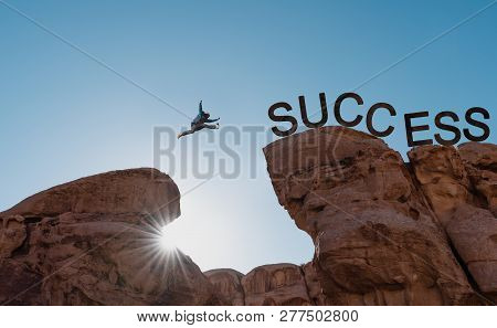 Silhouette A Man Jumping Over Precipice To Success.business Success, Challenge, Achievement And Lead