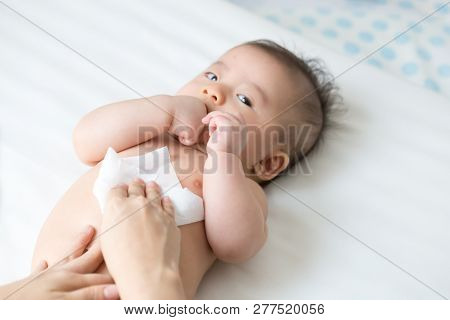 Mom Cleaning Up And Wipe Body Baby By Wet Tissue When Changing Nappies Or Diaper And Wiping The Hand