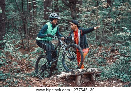 Moscow, Russia - Nov, 2018: MTB teacher helping rider learn to ride bicycle. Teaching a rider to rid