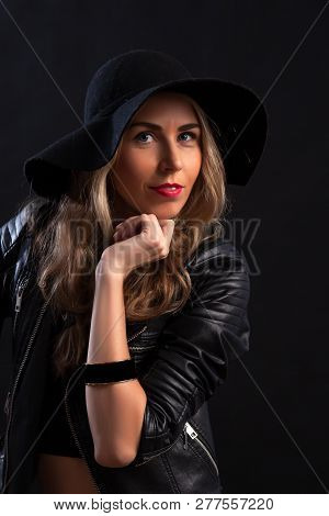Smiling Beautiful Young Woman In In Trendy Black T-shirt, Orange Skirt, Leather Jacket And Black Hat