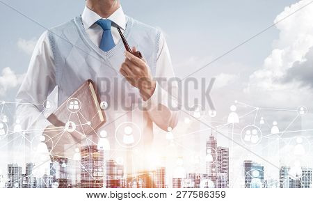 Double Exposure Of Confident And Young Businessman In Smart-casual Wear Smoking Pipe And Modern City