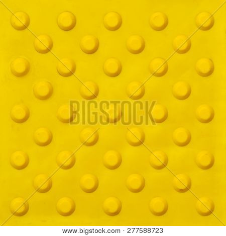 Top View Of Footpath Tiles On A Marble Texture Cover. Yellow Circle Buttons Pattern. A Stop Signal F