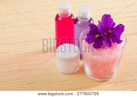 Shower Gel, Salt And Body Moisturizer On A Bamboo Mat