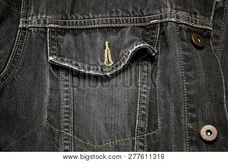 Detail Of Faded Black Denim Cowboy Jacket, Focus On Pocket.
