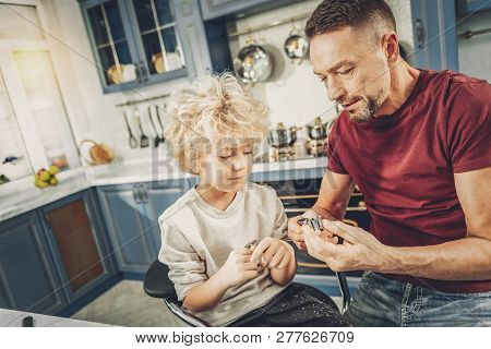 Concentrated Glad Man Demonstrating Boy Cookie Shapers
