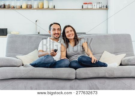 A Woman And A Man Watch Tv
