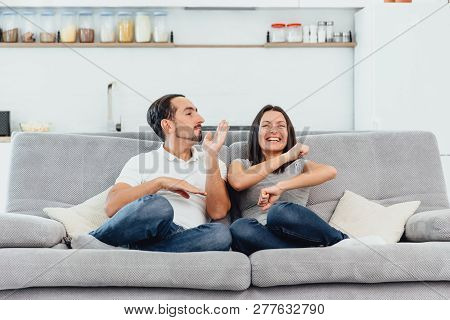A Woman And A Man Watch Tv