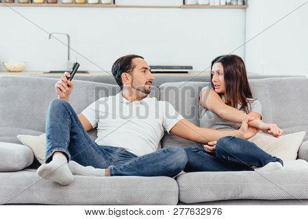 A Woman And A Man Watch Tv