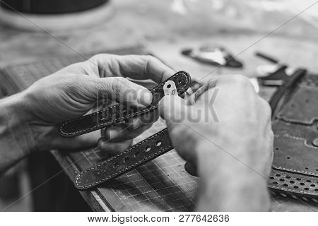 Professional Male Skinner, Tanner Working With Genuine Leather Belt At Workshop, Studio. Handmade An