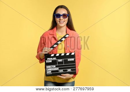 Woman With 3d Glasses And Clapperboard On Color Background. Cinema Show