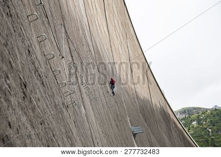 Finkenberg, Austria - June 9, 2018: An Alpinist Climbing The Via Ferrata On The Schlegeis Dam