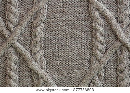 The Gray Texture Of The Knitted Fabric With A Pattern Of Braids And Stripes .cable Pattern Backgroun