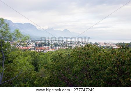 Panoramic View From The Mountain Of The City Of Kemer In Turkey. Mountains, Sea, Clouds, Lagoon