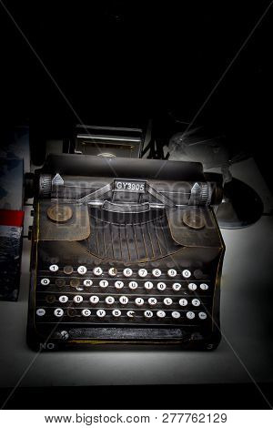 Retro Syled Tiny Typewriter Model On A White Background