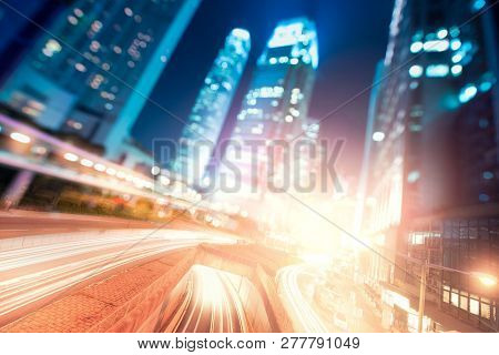 Hong Kong Business District And Density Residential At Night With Light Trails On The Street Movemen