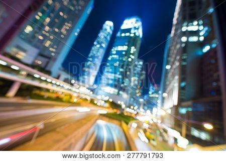 Hong Kong Business District And Density Residential At Night With Light Trails On The Street Movemen