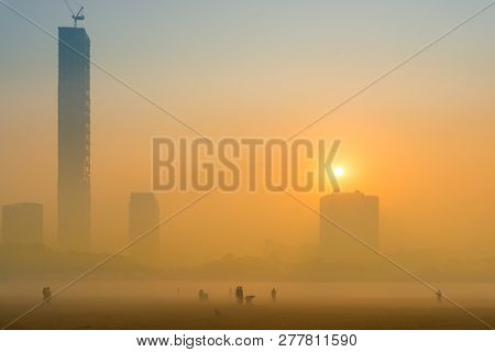 Beautiful Image Of Sunrise At Kolkata Maidan In A Foggy Winter Morning. Sunrises At The Horizon Abov