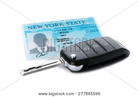 American Driving License And Car Key On White Background