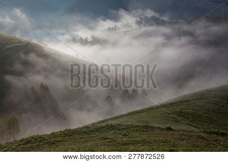 foggy summer landscape in the mountains, Salciua, Romania